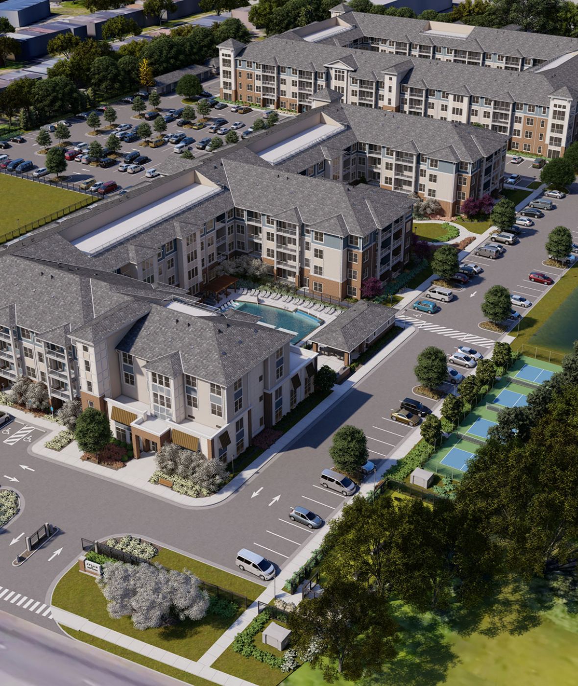 Attain at Newtown apartment homes with Aerial view of a modern apartment complex with pool, parking lots, and landscaped areas beside a pond and busy roads.